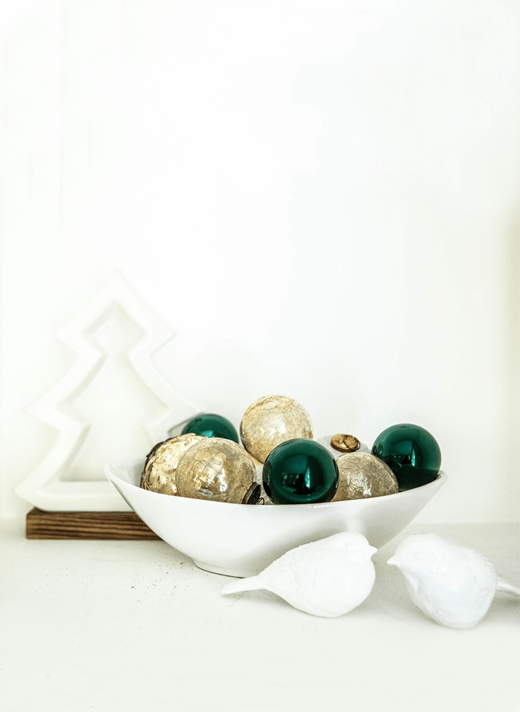 Modern Christmas ornaments in a white bowl
